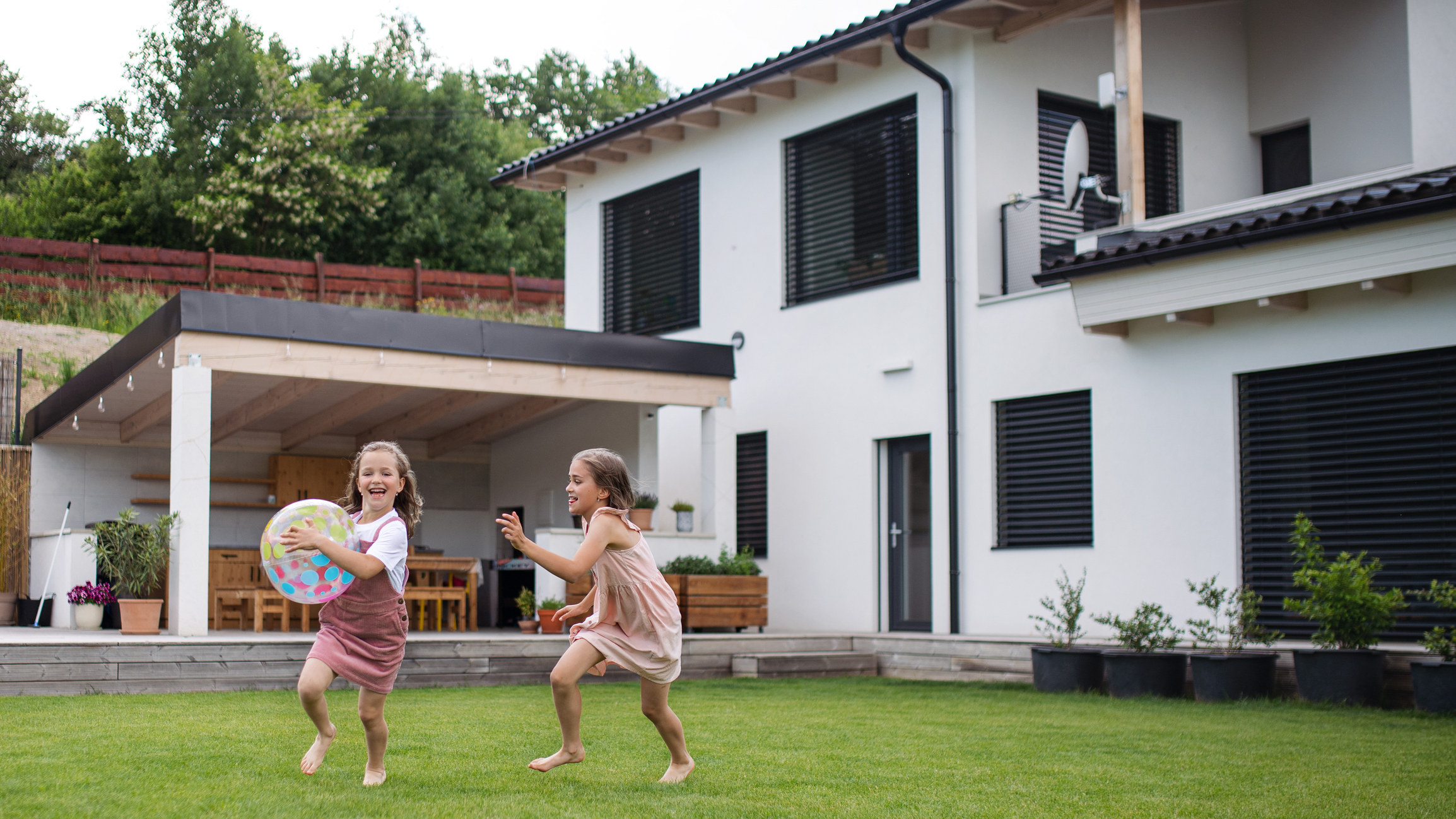 Two kids safely enjoying their backyard bug free.