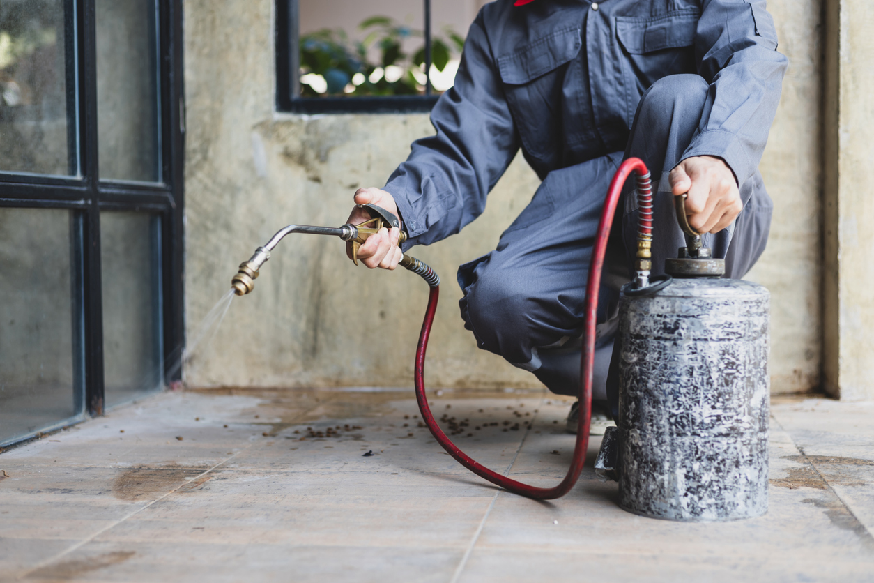 Service technician treating the exterior of a Las Vegas home.